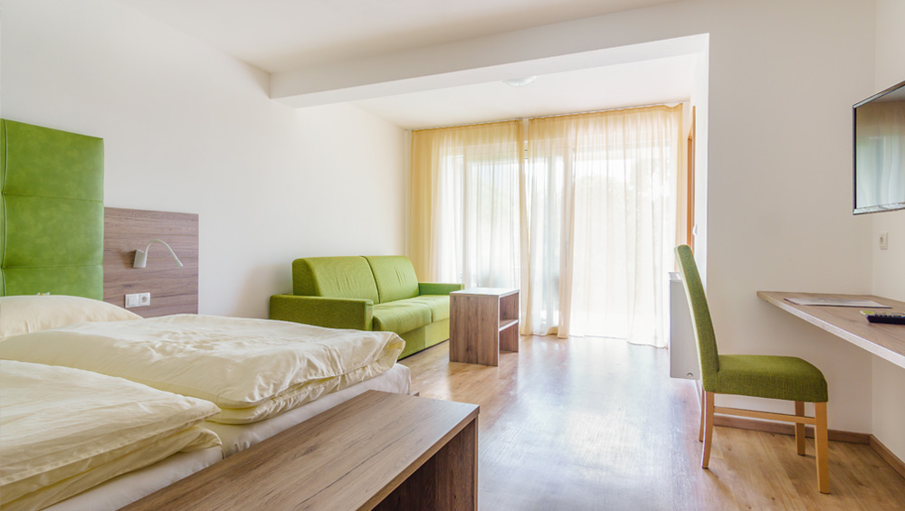 Doppelzimmer-Komfort-6-gruen-sofa-terrasse
